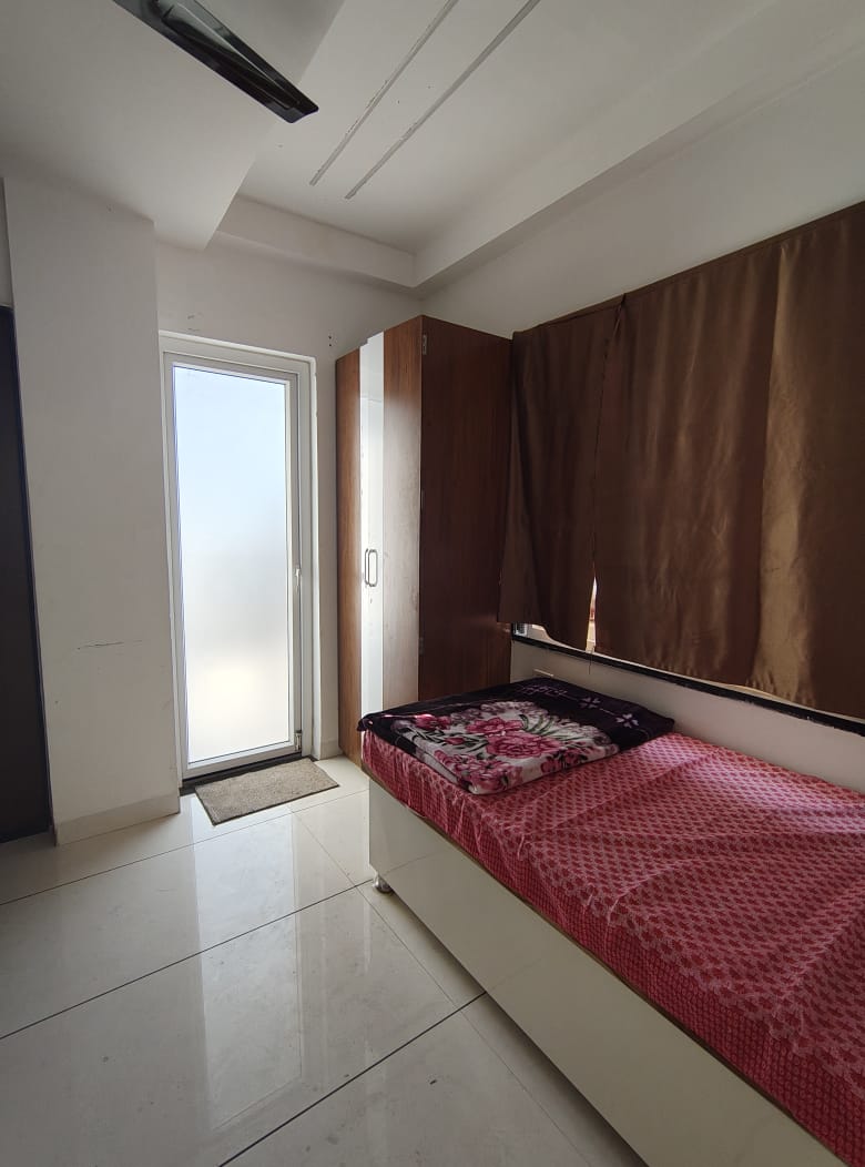 Room with bed near balcony door