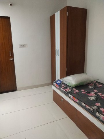 Room with ceiling fan and wooden wardrobe