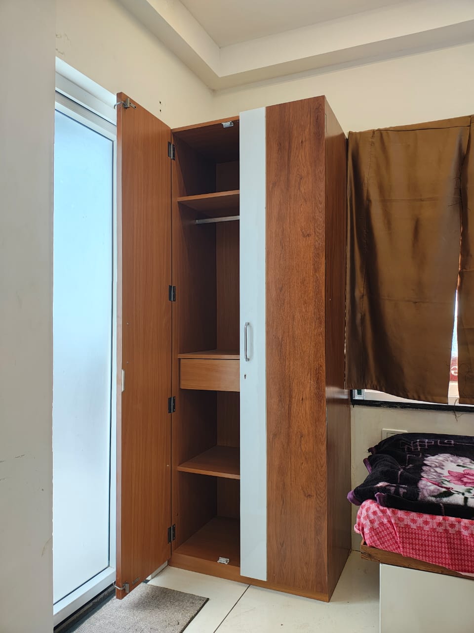 Spacious wooden wardrobe with mirror and drawer